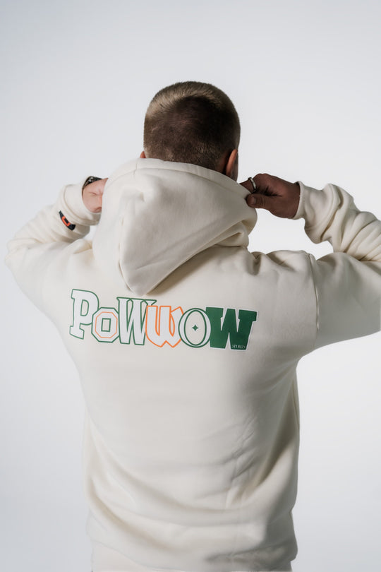 Rückansicht eines Models, das den POWWOW Signature Hoodie CREAM (Off-White) mit großem Logo-Backprint trägt.